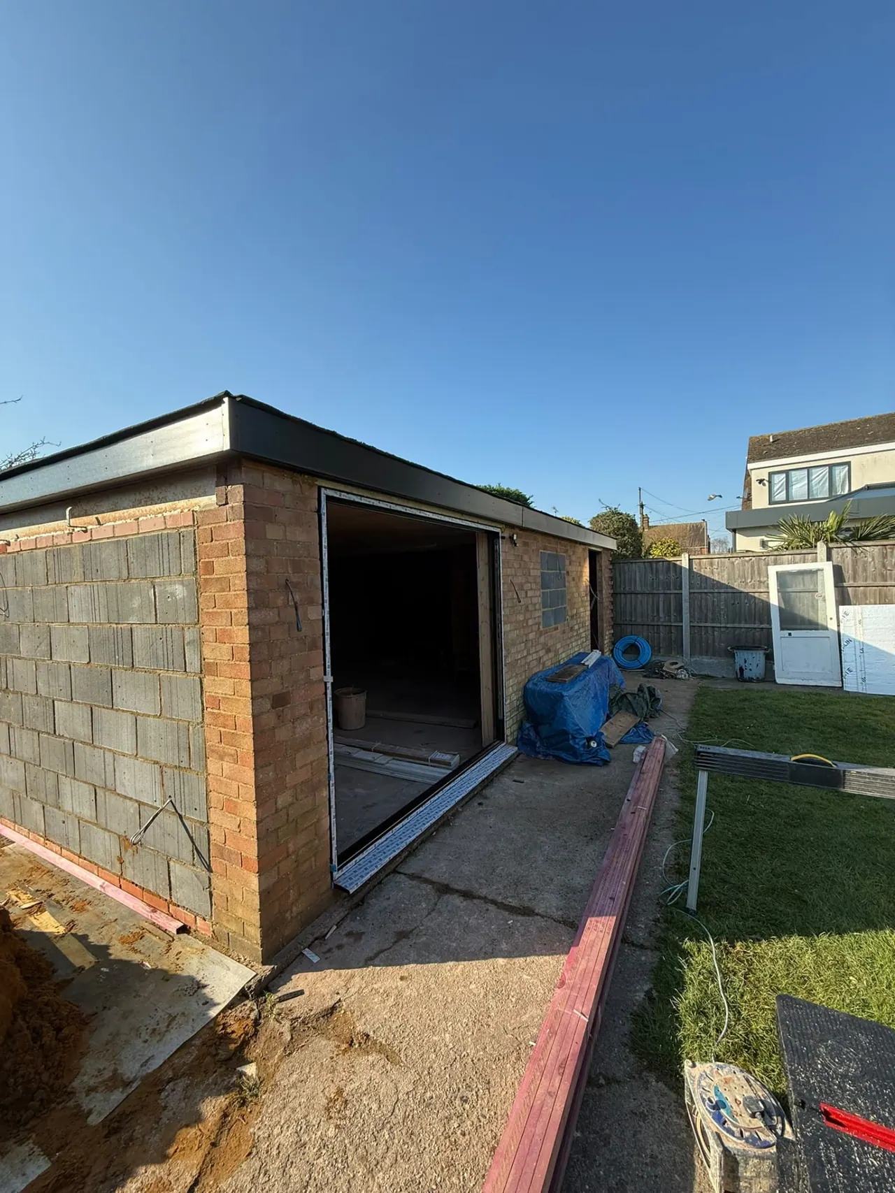 Garden room under construction with block walls and timber roof in Essex