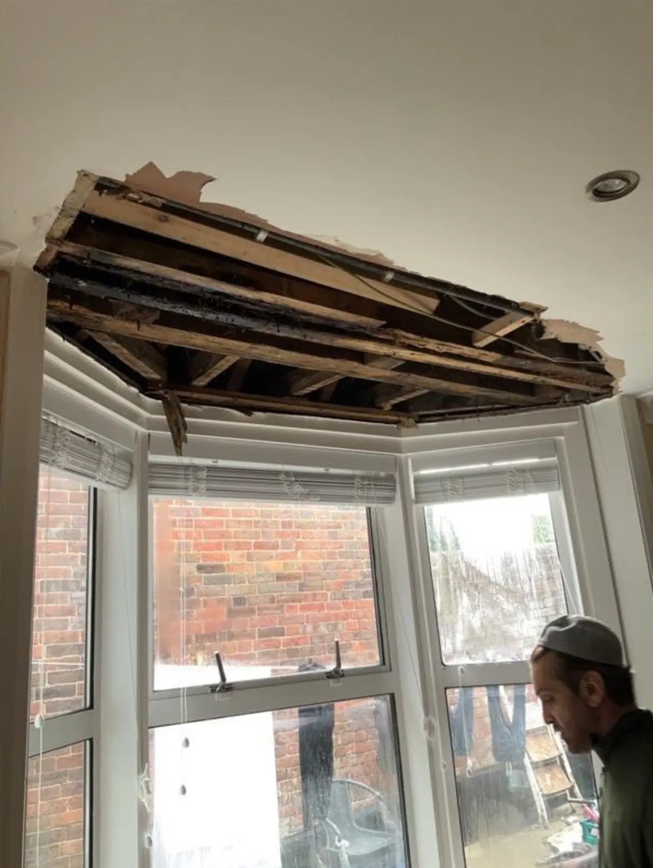 Damaged bay window ceiling stripped back before replastering