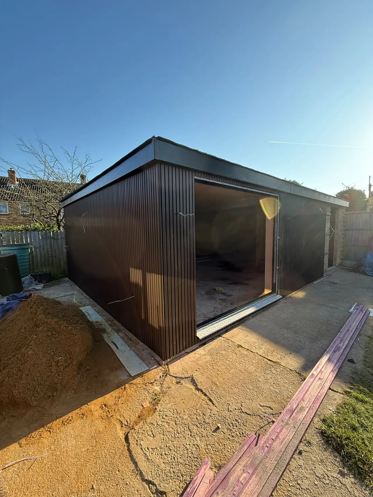 Completed garden room with dark cladding and sliding glass doors in Essex
