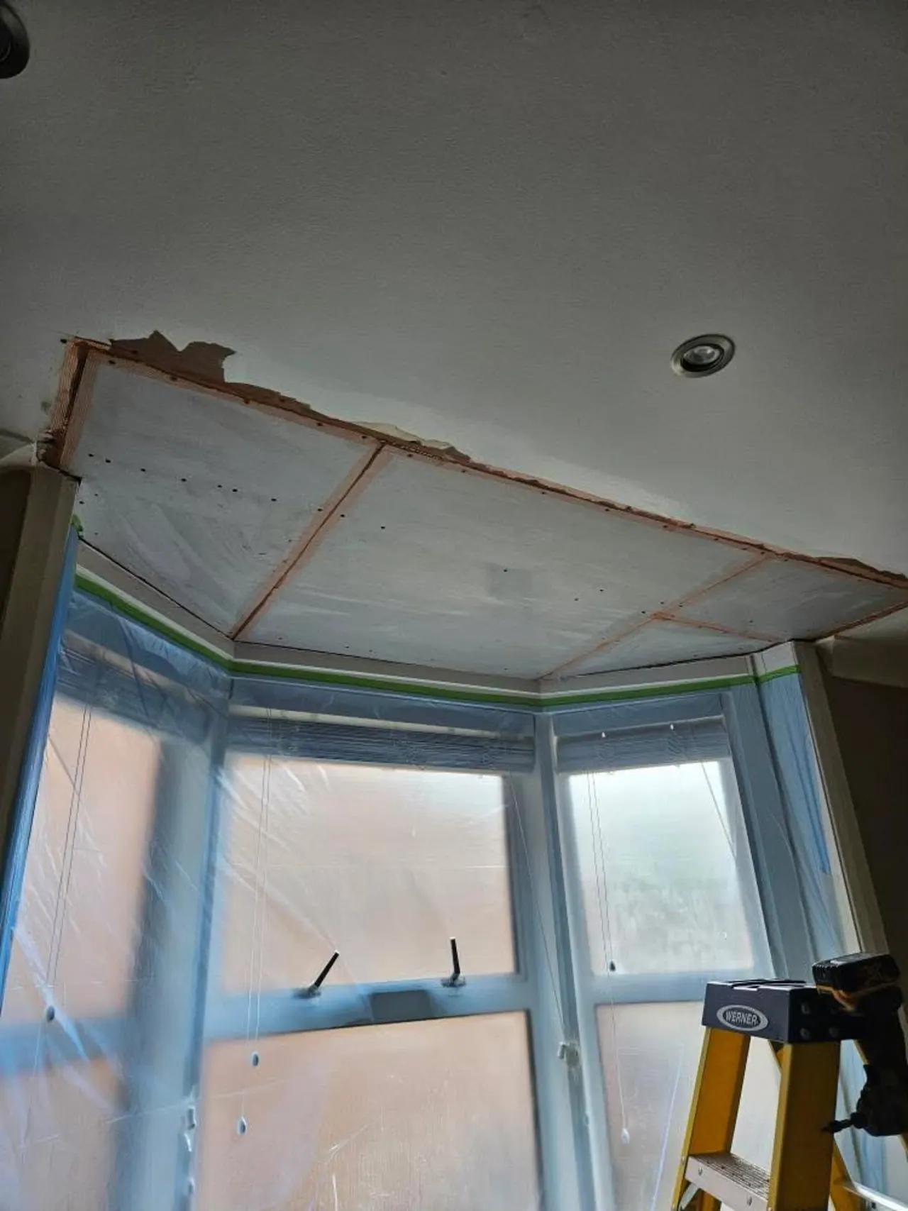 Damaged bay window ceiling stripped back before replastering